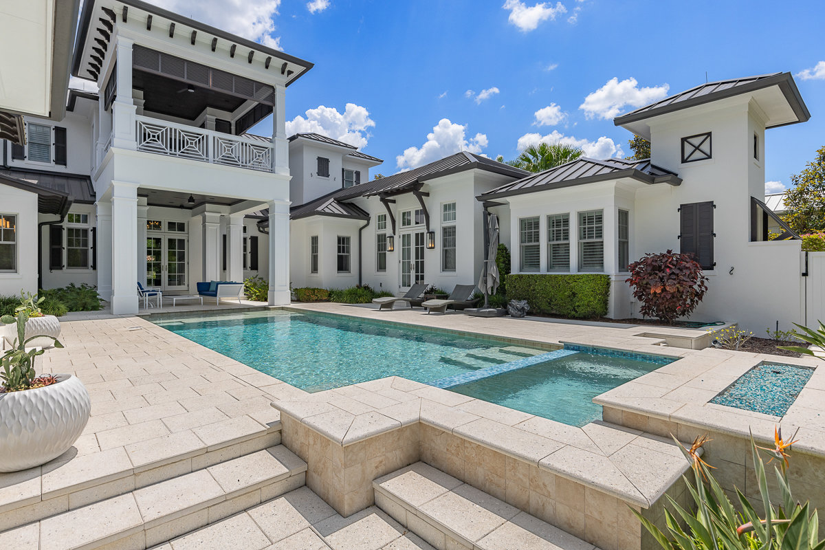 pool with stone work and white modern architecture